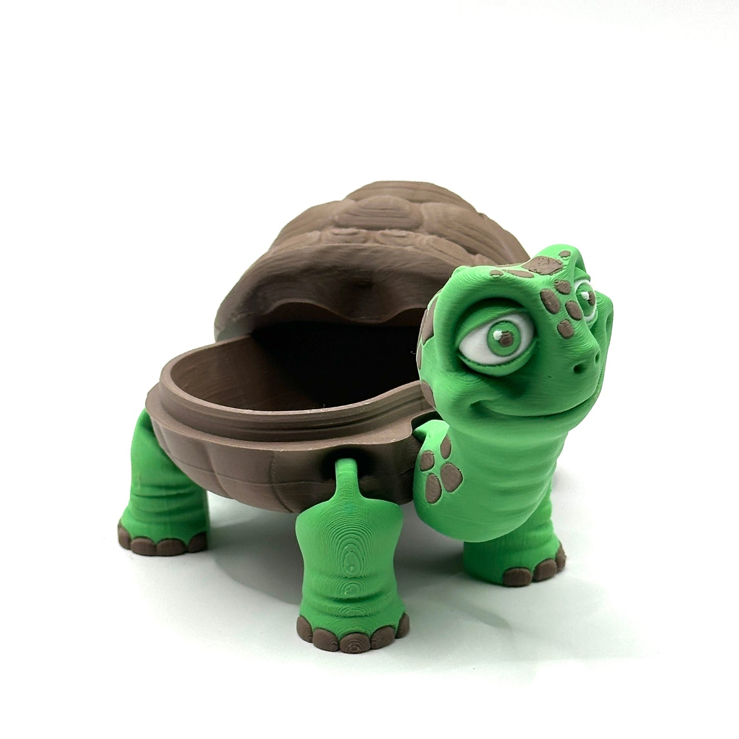 Green turtle toy with a brown shell on a white background