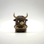 Udderly Done Highland Cow 3D printed desk buddy holding its sign, front view