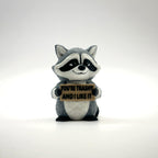 You're Trashy and I Like It Raccoon 3D printed desk buddy holding its sign, front view
