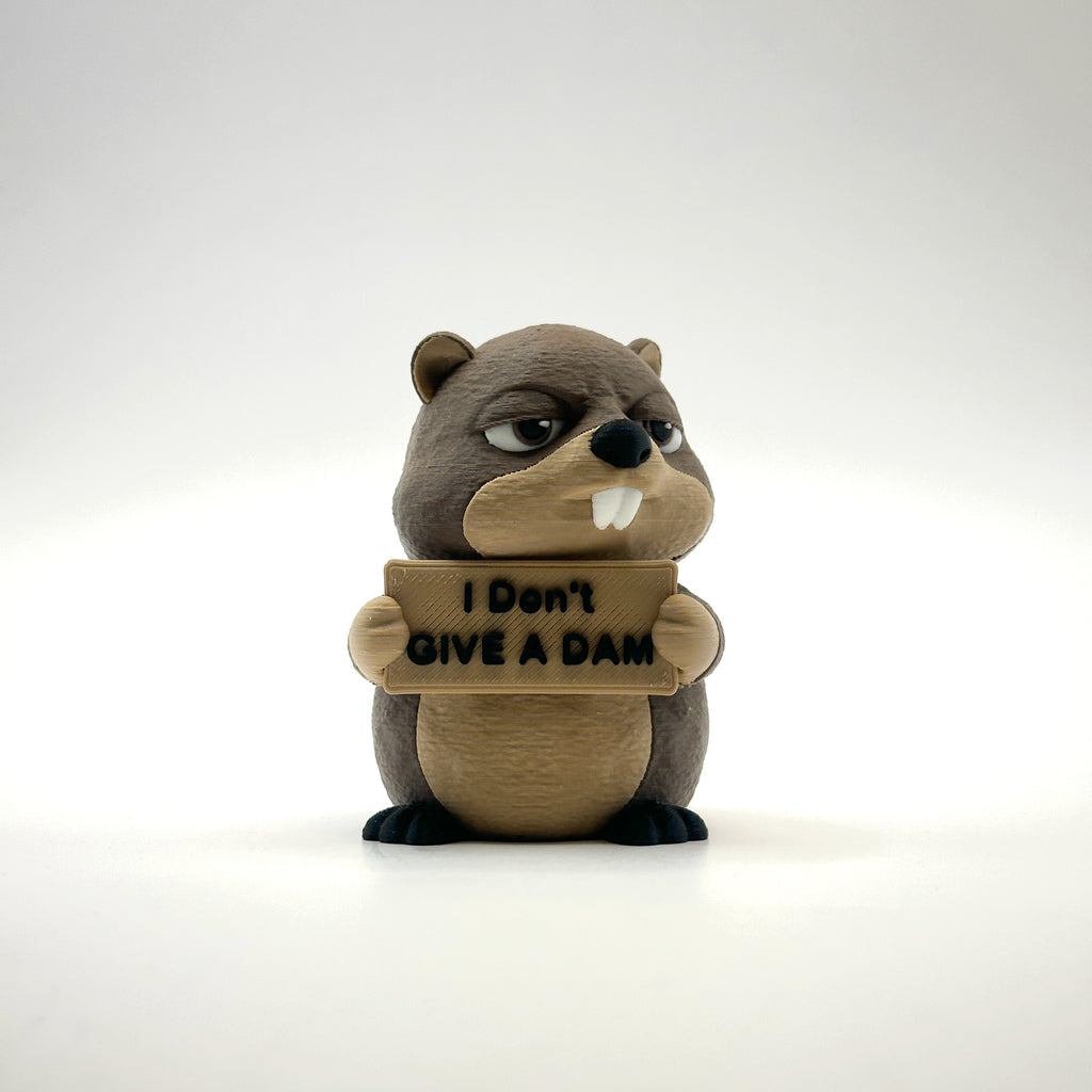 I Don't Give a Dam Beaver 3D printed desk buddy holding its sign, front view